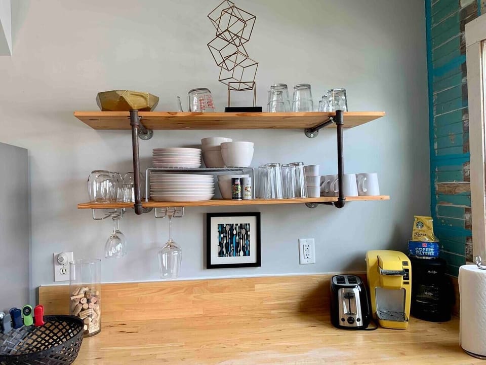 Kitchen has a simple, utilitarian look with the use  of raw materials and tough fixtures.  The finishes take center stage
Small appliances include a Keurig, 5c Mr. Coffee, Blender, & Toaster