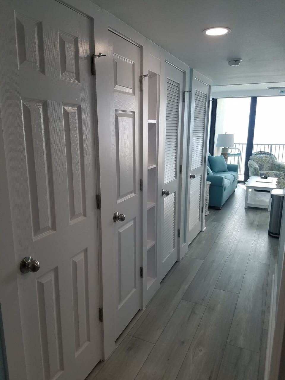 Hallway with closets and w/d