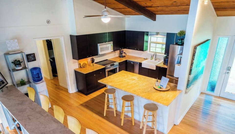 Bird's eye view of vaulted kitchen area including bar seating, with a view of the lake!