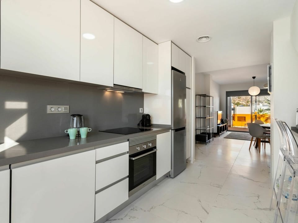 Cabinetry, Countertop, Property, Furniture, Building, Kitchen, Interior Design, Lighting, Kitchen Stove, Chair