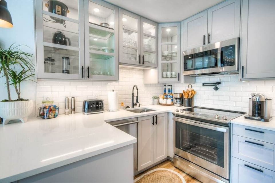 Use the functional stainless steel appliances (dishwasher, full size refrigerator and stove) and clutter-free quartz countertops in the custom kitchen to prepare your meals