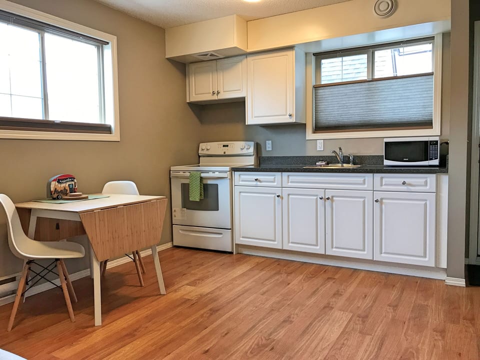 Kitchen equipped with full-sized appliances, dishware, cookware, and utensils