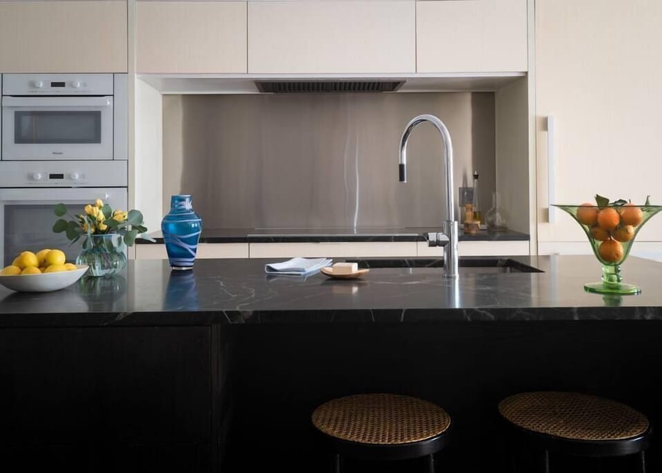 The chef's kitchen includes an induction range and convection oven.