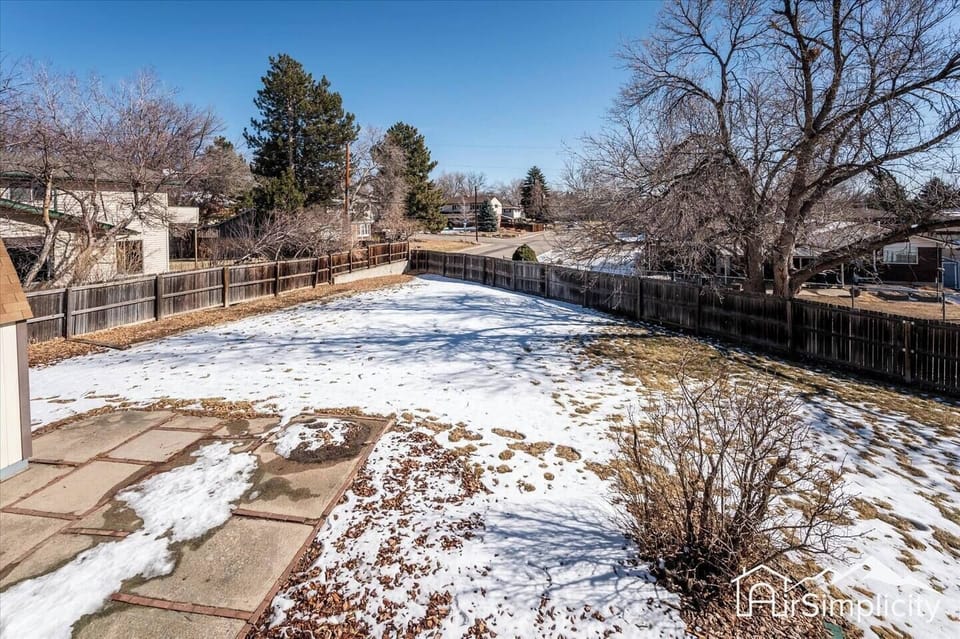 - Large fenced backyard with mature trees, spacious layout, and wintertime charm
- Perfect for snowball fights or summer barbecues once the weather warms up
- Patio area and plenty of open ground for lawn games or stargazing nights