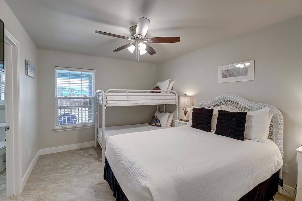 Your spacious bedroom features a comfortable bed plus bunk beds, perfect for families or groups seeking flexible sleeping arrangements.