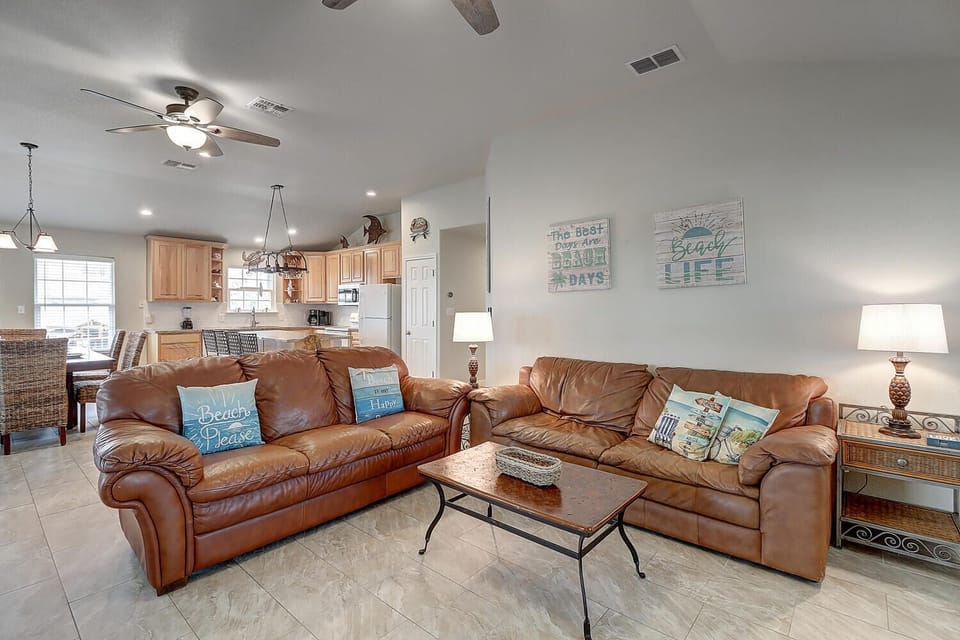 Open living room - Soft, comfortable seating, and ocean-inspired details create a welcoming space perfect for unwinding after a day by on the coast