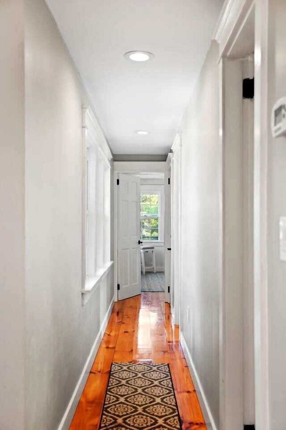 Hallway leading to 2 bedrooms and bathroom.