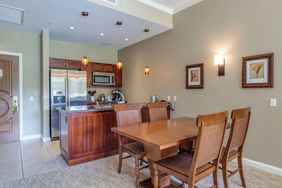 Warm kitchen and dining area with pendant lighting and decor.