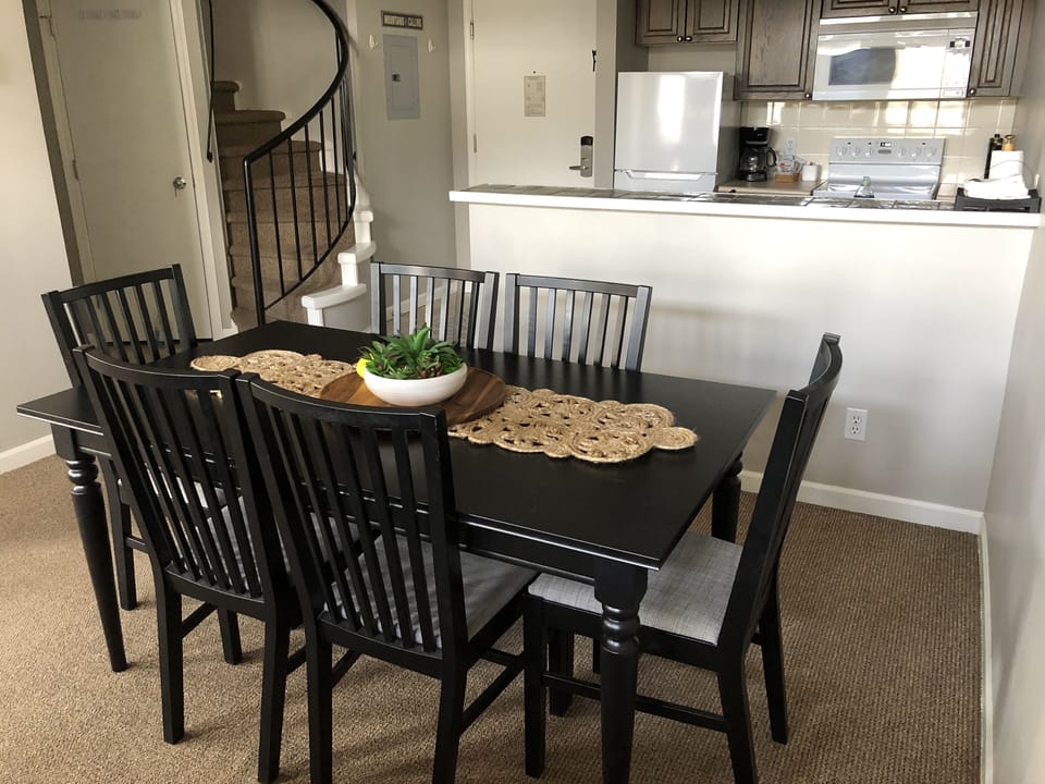 Kitchen & eating area with stairs to the loft in the background