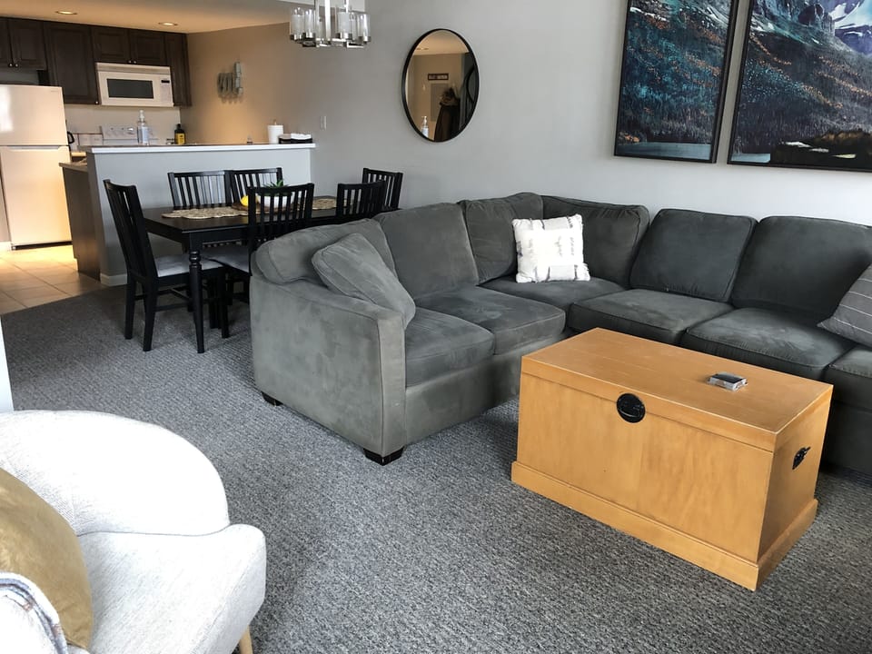 Living room with eating area and kitchen in the background