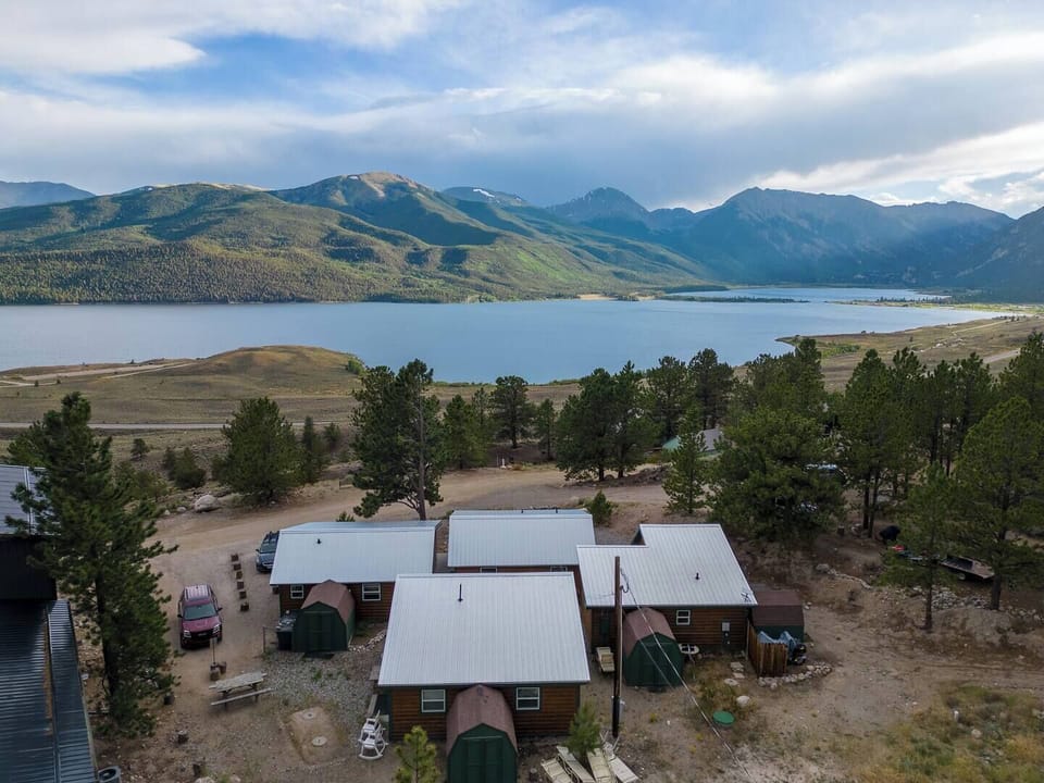 - Breathtaking panoramic view of the lake backed by majestic green mountains
- Nestled among tall pines, these rustic cabins offer a peaceful mountain escape
- Just steps from nature with hiking, kayaking, and relaxing right outside your door