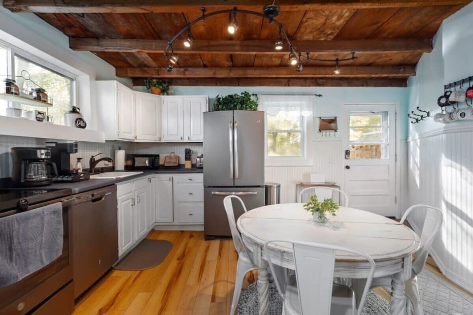 Fully equipped kitchen with updated appliances and 4 person dining table.