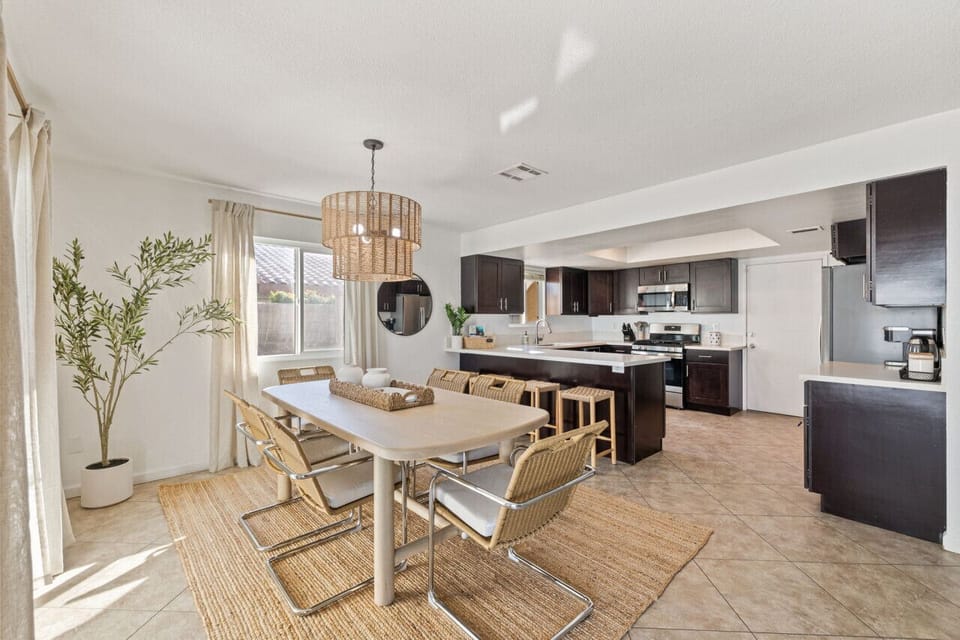 Airy dining area w/ modern table set just off the kitchen for easy shared meals