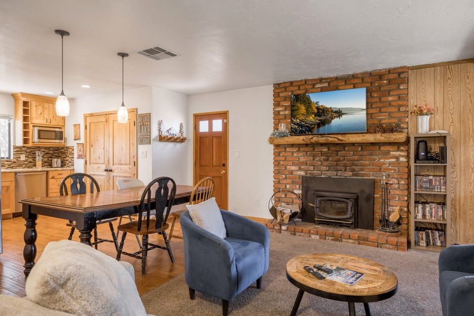 Open living & dining room w/ brick fireplace & plush seating for the whole group.