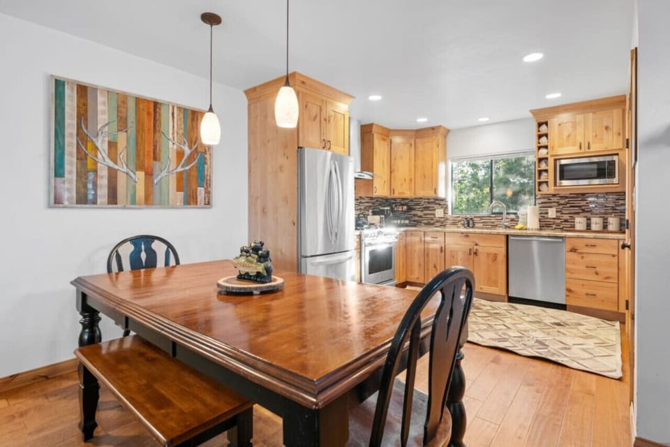 Warm wood dining table set beside the kitchen, perfect for shared meals and easy conversation.