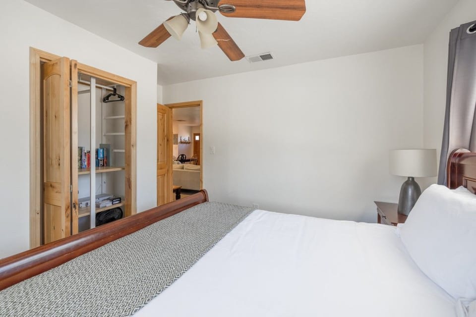 Bedroom w/ sleigh bed & closet, opening to the hallway.