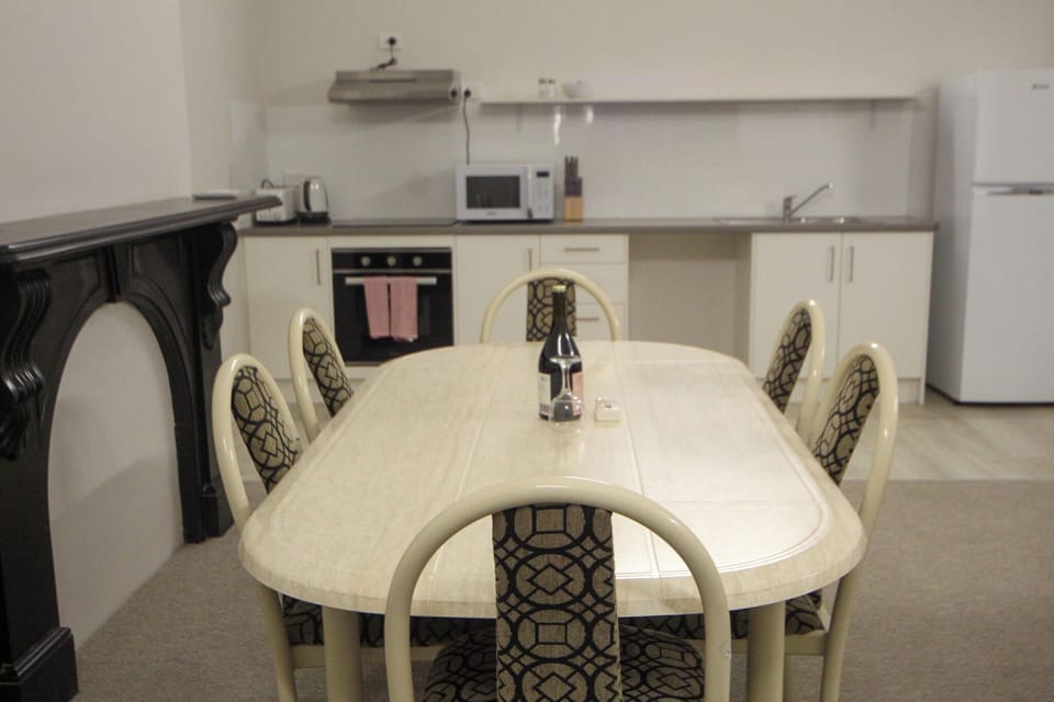 A full-sized dining table provides the perfect setting for shared meals, celebrations, or planning the next day’s adventures. (Wine pictured is for styling purposes only.)