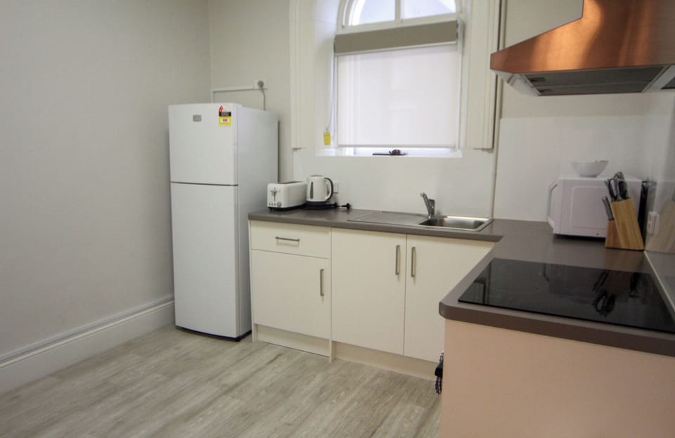 Open plan lounge, dining, and kitchen areas with smart TV, free WiFi, split system air conditioning, modern kitchens, and refurbished bathrooms in each unit featuring contemporary fixtures for guest comfort.