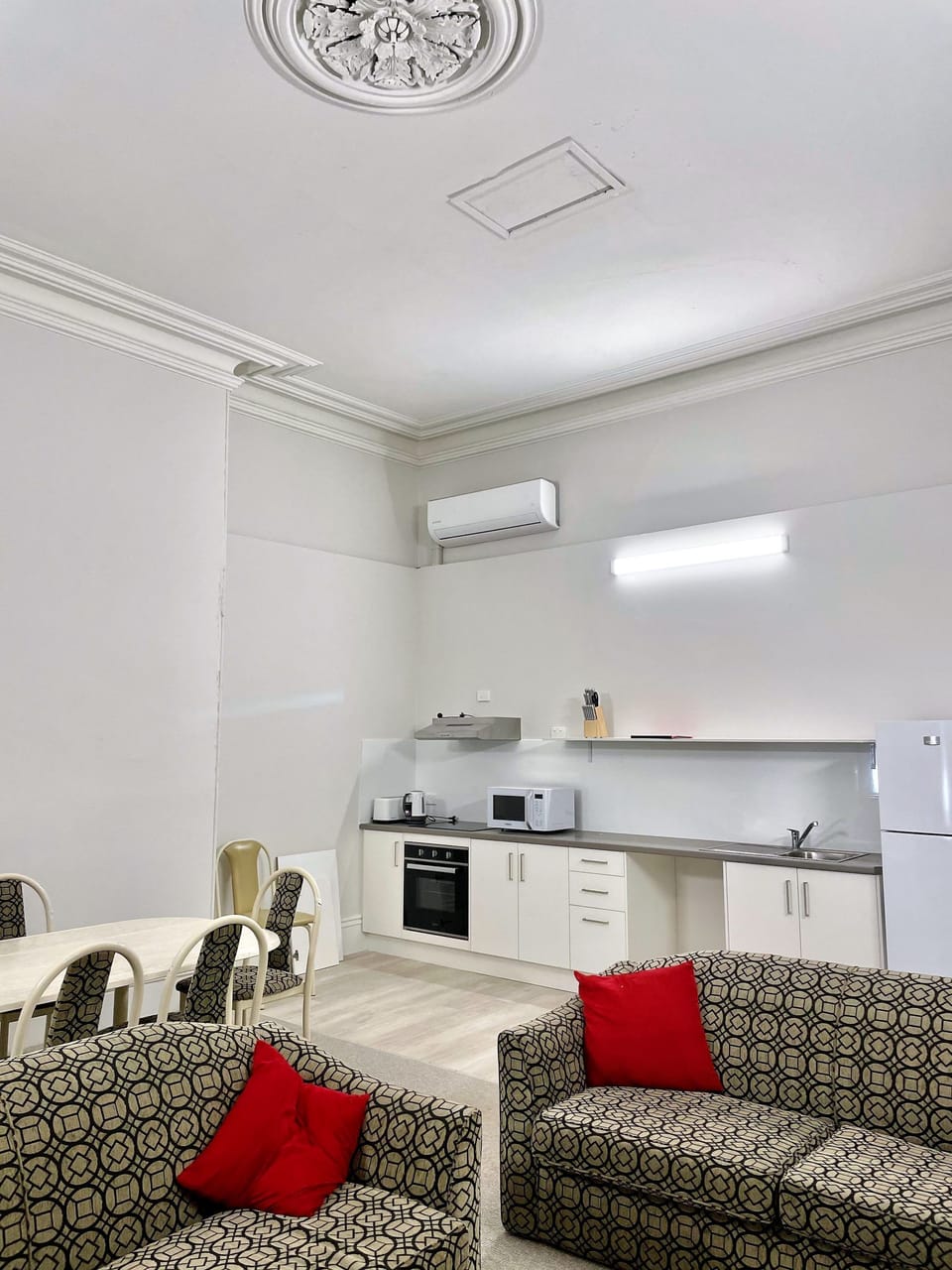 Open plan lounge, dining, and kitchen areas with smart TV, free WiFi, split system air conditioning, modern bathrooms, and well-appointed kitchens.
