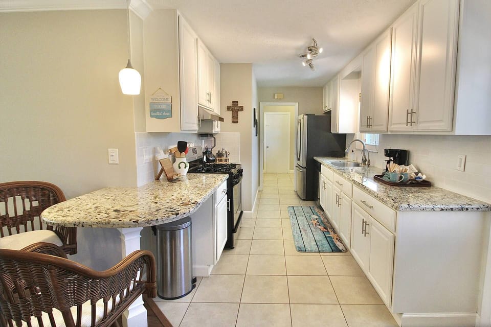 The bright kitchen has been updated with granite countertops and stainless steel appliances.