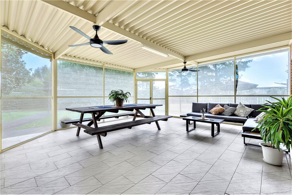 Out door area , with large table and outdoor lounge .