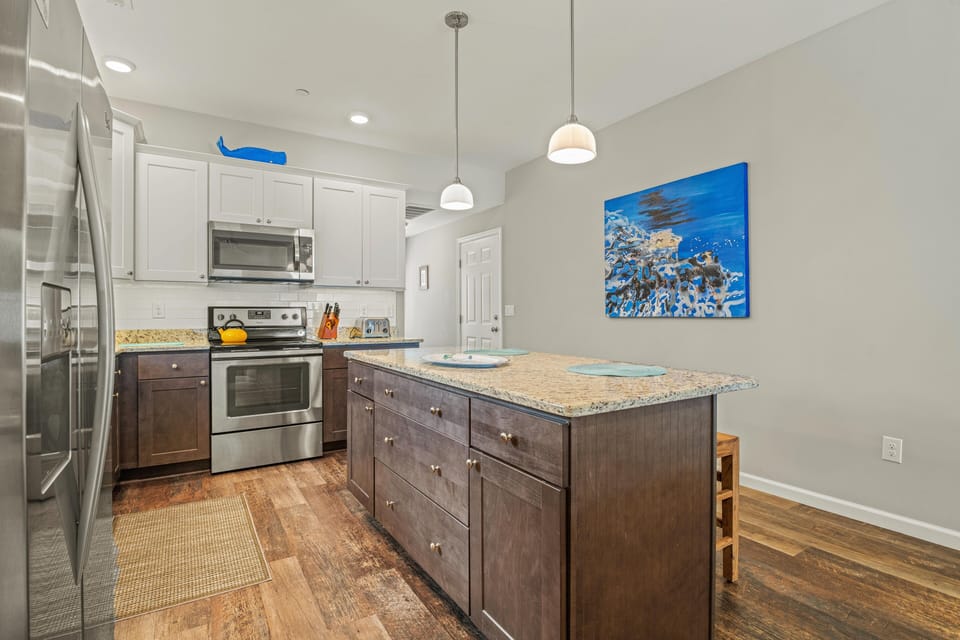 Kitchen with Bar Stool Seating on First Level