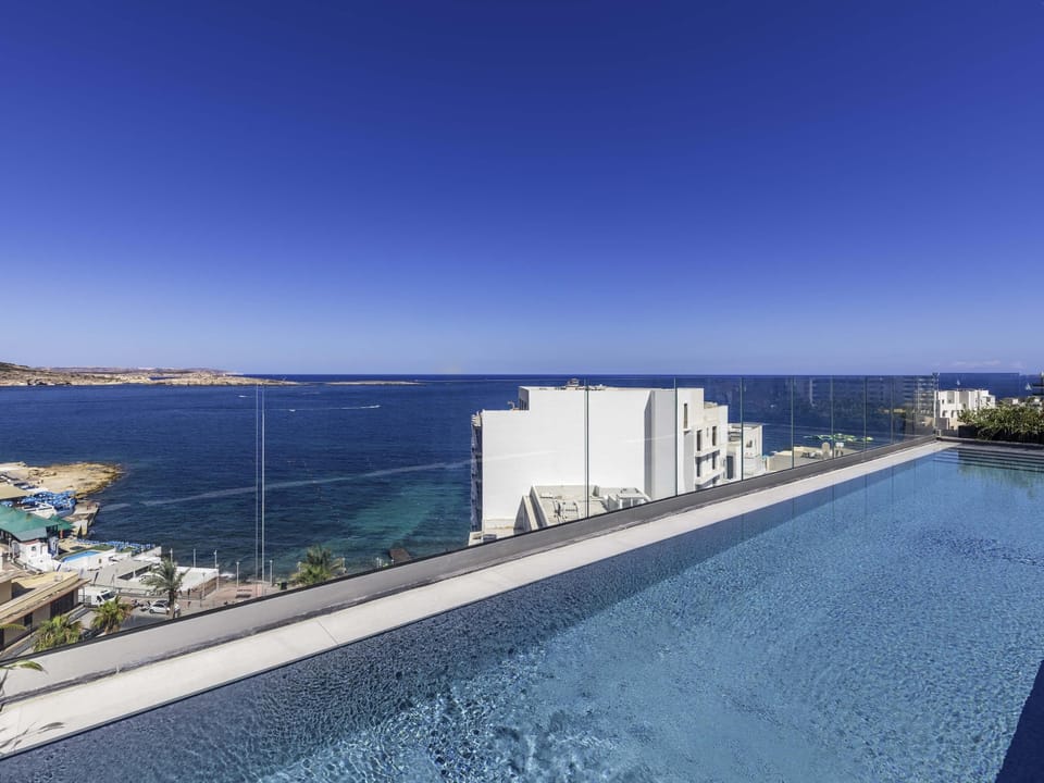 Seasonal outdoor pool, open 7:00 AM to 8:00 PM, pool umbrellas