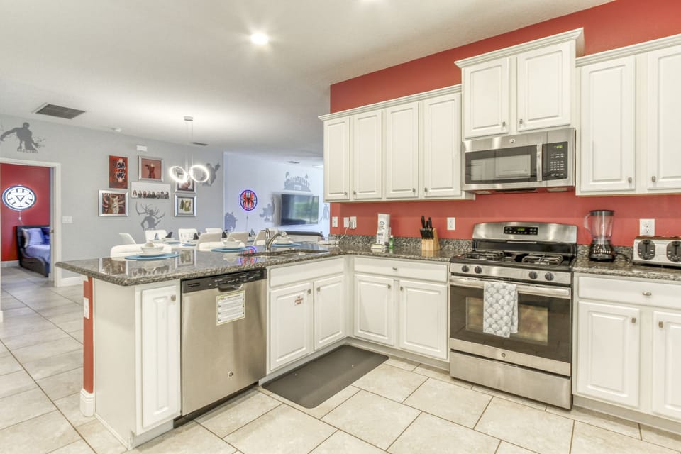 The kitchen features granite countertops and stainless steel appliances.