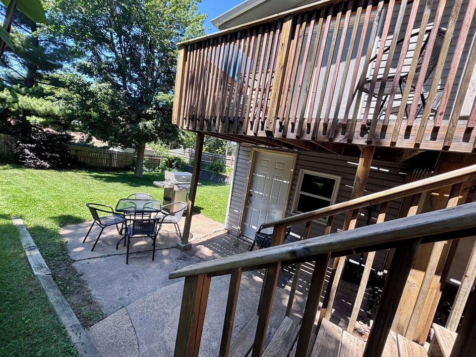 Outdoor deck & patio with a propane grill. Backyard is fully fenced in.