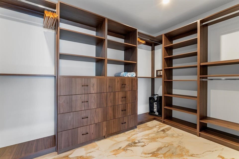 Wooden hangers, beach towels, a coded safe and laundry bag in our walk-in closet