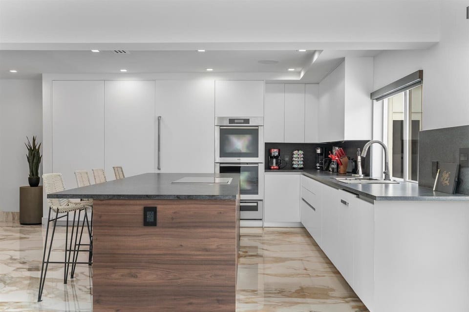 Stainless steel appliances. Fully equipped kitchen, assortment of coffee pods.