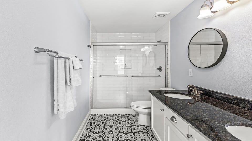 En-suite master bathroom with double sinks, large shower, and soaker tub.