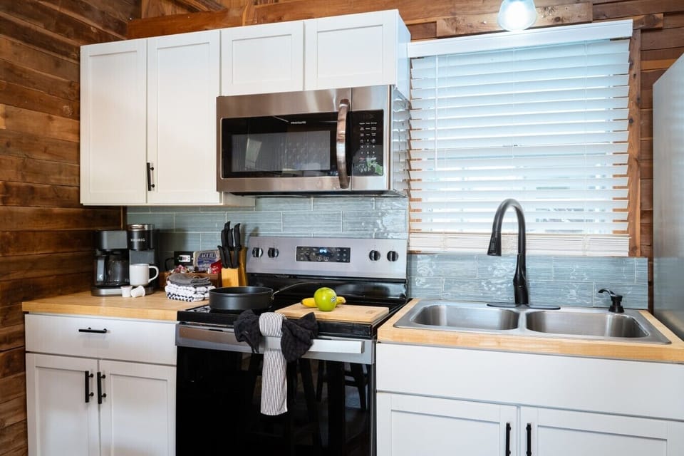 Fully stocked kitchen with utensils, pots and pans, coffee maker, and toaster