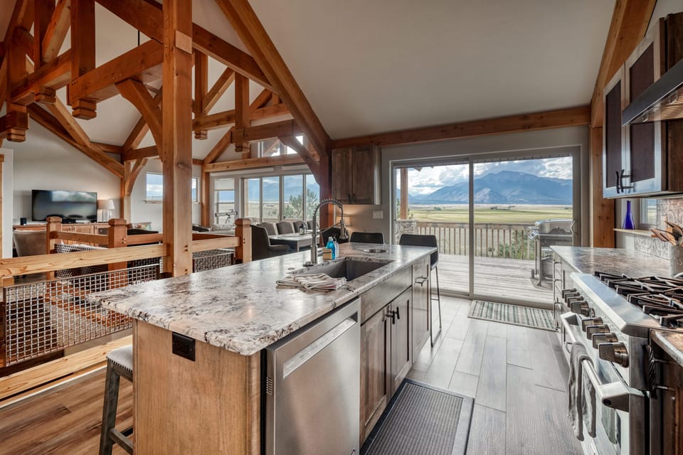 There is a sliding glass door leading to the deck and gas grill.