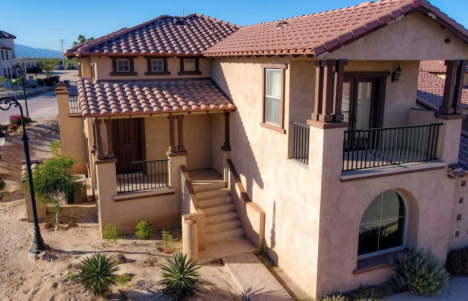 The front exterior of Condo 17-3 features a classic El Dorado Ranch design with a private entry and garage access, situated near community pools and golf course views.