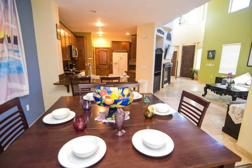 The formal dining room sits right off the gourmet kitchen and features a sturdy dining table with seating for six — perfect for family-style dinners after a day at the beach