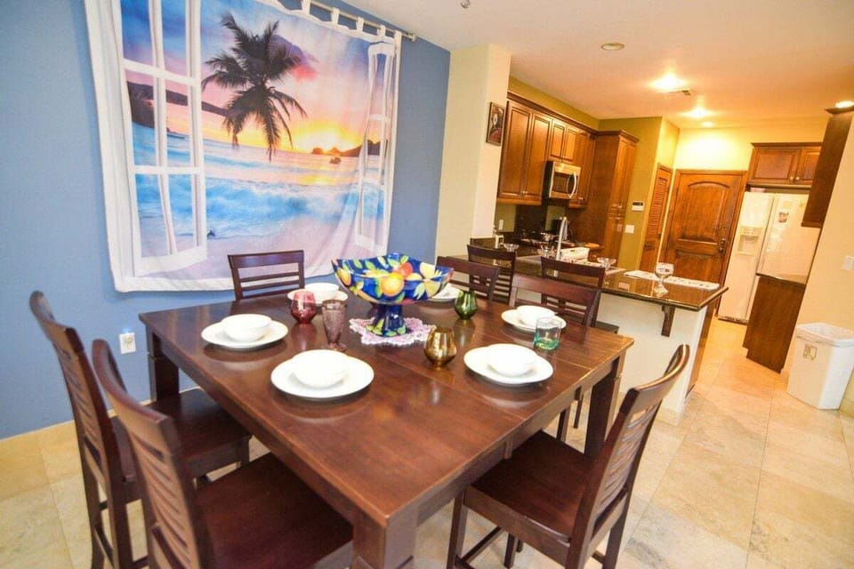 The formal dining room at Condo 4-4 sits right off the gourmet kitchen and features a sturdy dining table with seating for six — perfect for family-style dinners after a day at the beach