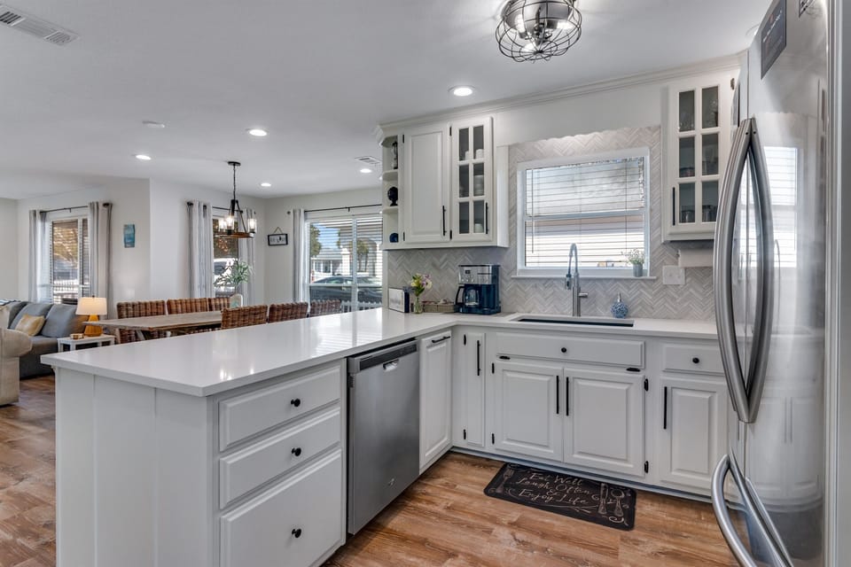 Brand new quartz countertops really make this beautiful white kitchen POP!