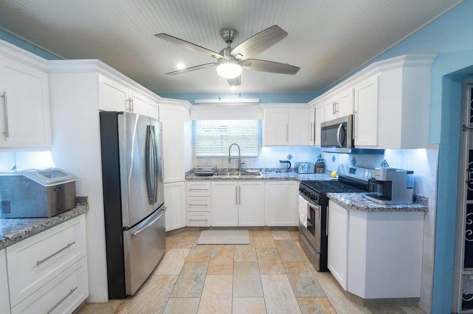 A chef’s dream with granite countertops, breakfast bar, incredible high-end stainless steel appliances