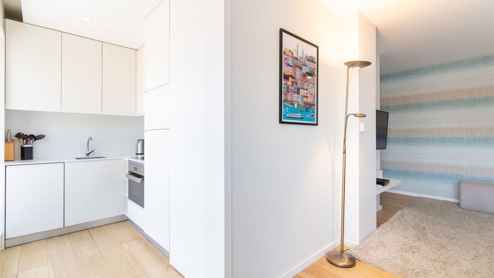 Experience seamless living with an open-plan layout connecting the sleek, fully-equipped kitchen to a comfortable living area. Modern decor and thoughtful lighting create an inviting atmosphere for both cooking and unwinding.