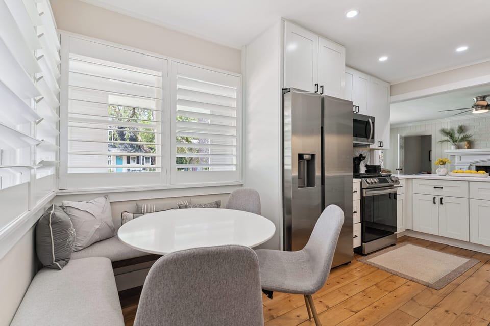 Gather at the bright breakfast nook and enjoy morning coffee while natural light filters through plantation shutters. The fully-equipped kitchen makes preparing meals a breeze, with stainless appliances and ample counter space just steps away.