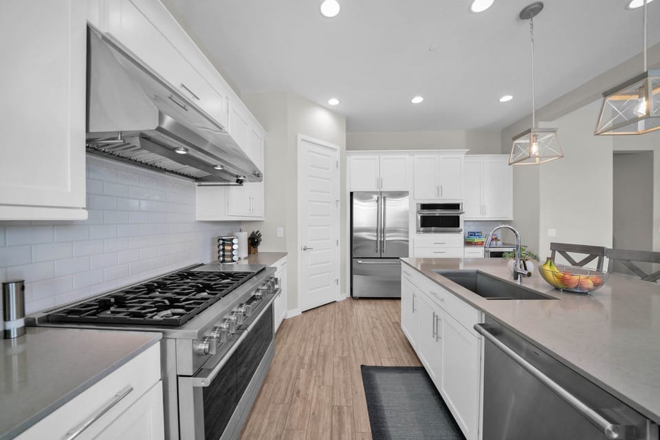 Monogram gas six-burner range w/ LED lights, griddle and two ovens. 