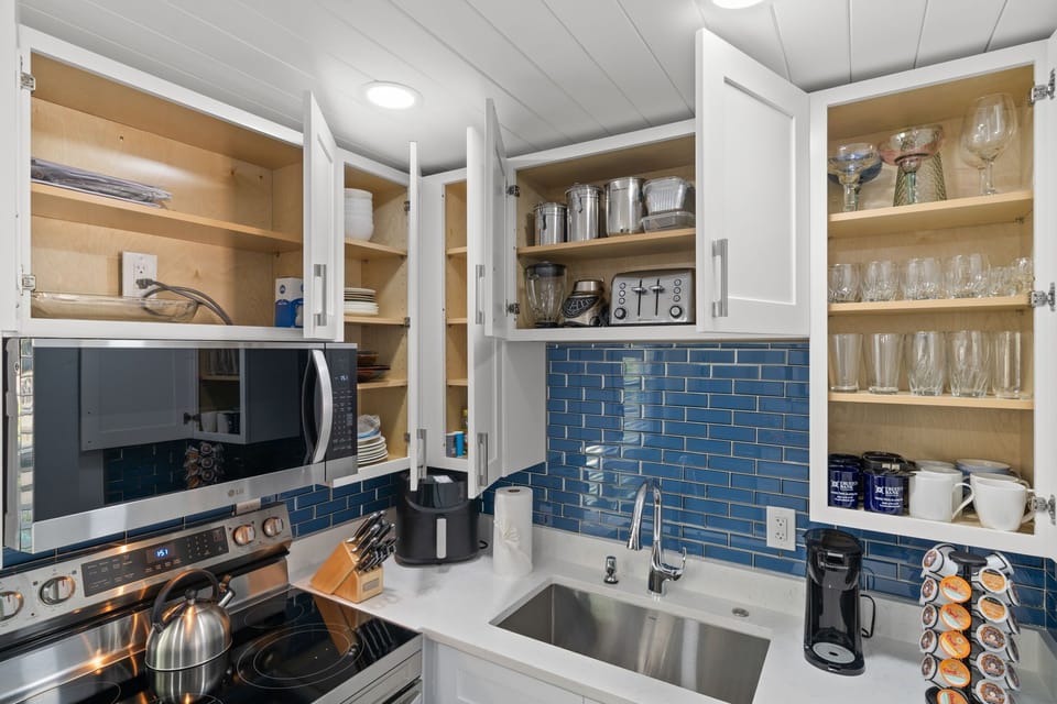 Kitchen fully stocked with cooking ware 