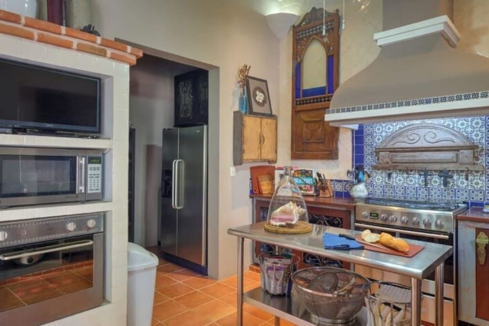View of the kitchen pantry, with freezer/fridge, storage, and washer/dryer.