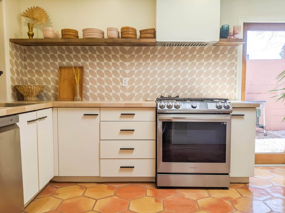 Fully stocked kitchen with new appliances and gas range.
