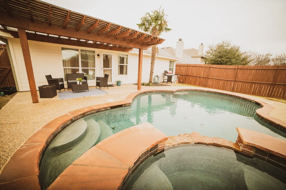 Pool + hot tub with pergola and patio sitting plus a grill and outdoor fire pit