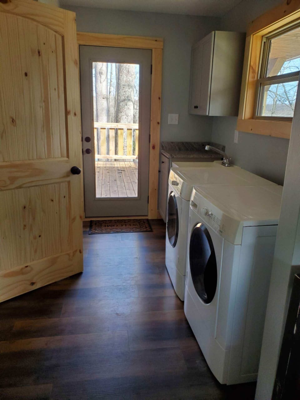 laundry room with washer and dryer. single bay sink with cabinets 