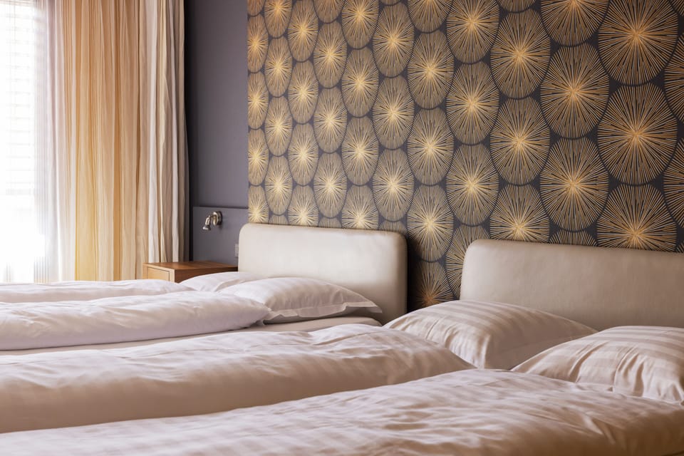 Family Quadruple Room | Down comforters, minibar, desk, laptop workspace