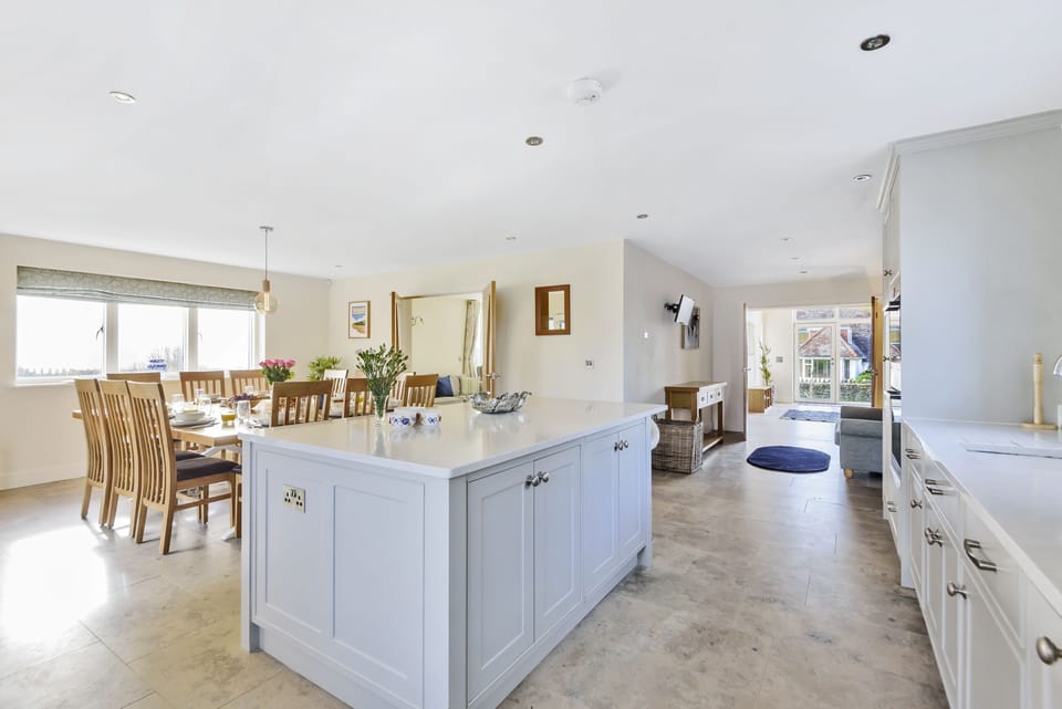 All Views, Burton Bradstock: The kitchen island and open-plan dining room