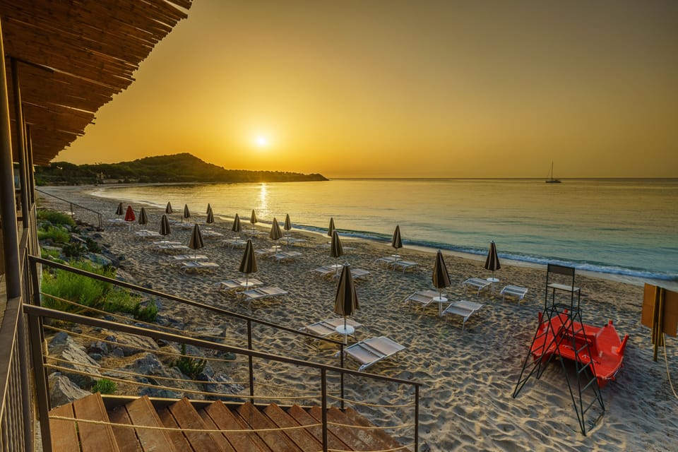 On the beach, white sand, sun loungers, beach umbrellas
